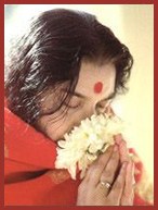 Shri Mataji Nirmala Devi smelling white flower Shri Mataji Nirmala Devi smelling white flower