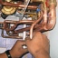 hands grasping copper pipe below boiler hands grasping copper pipe below boiler