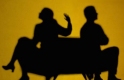 silhouette of arguing couple facing opposite directions