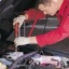 car servicing, mechanic with screwdriver, under the bonnet car servicing, mechanic with screwdriver, under the bonnet