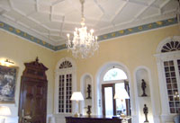 large room with a chandelier, ornate mouldings and decoration large room with a chandelier, ornate mouldings and decoration