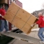 two men carrying a wardrobe up a ramp into a van two men carrying a wardrobe up a ramp into a van
