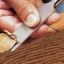 hand cutting a sliver of wood with a chisel hand cutting a sliver of wood with a chisel